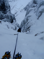 Using an ice screw to protect a steep section, Lochnagar